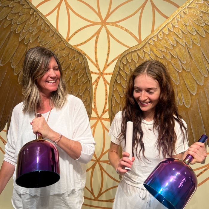 A collection of crystal singing bowls arranged for a sound healing session, used to enhance meditation and vibrational therapy training in Sedona.