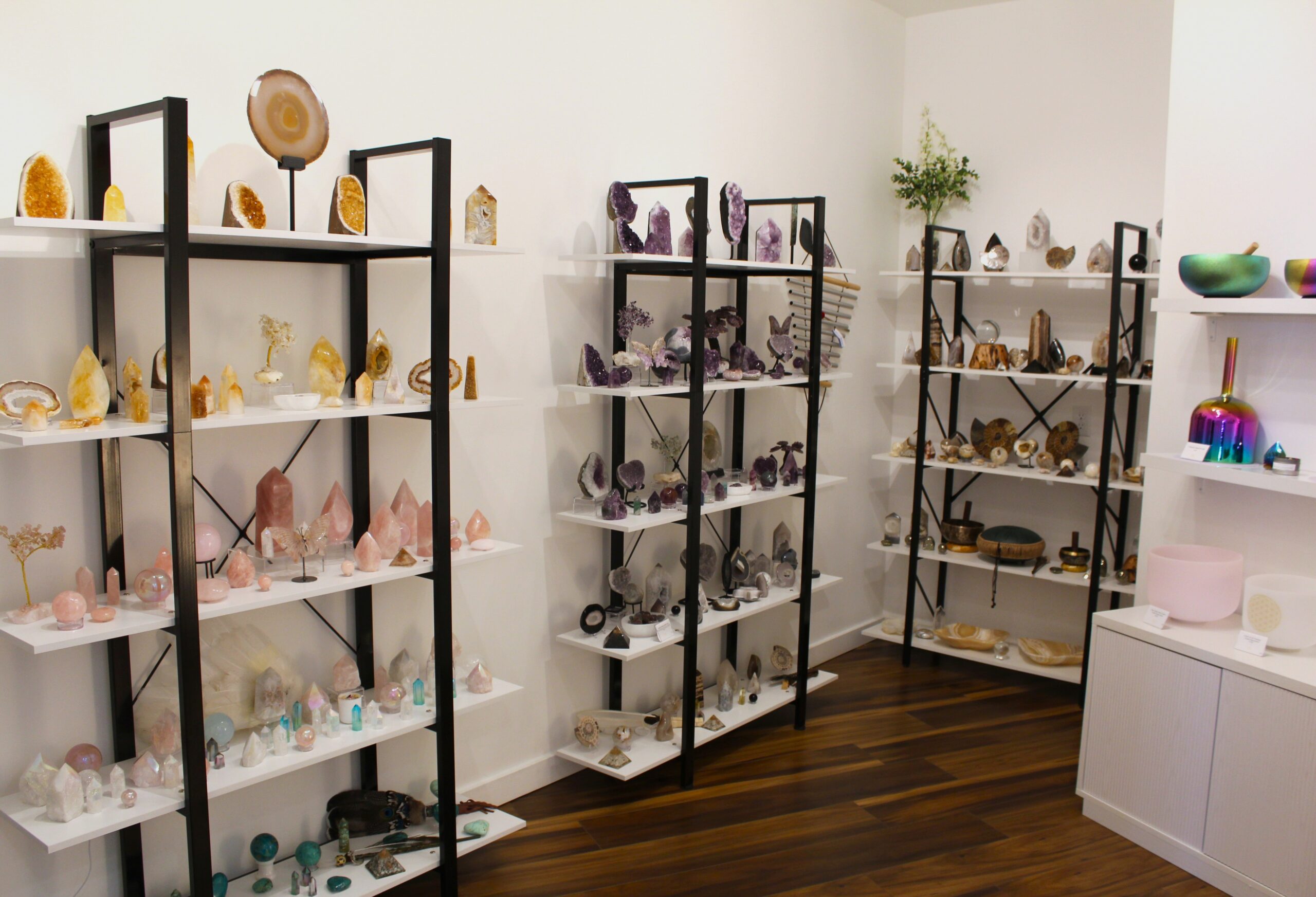 Sound healer performing with sacred instruments and altar in a high-vibe Sedona venue rental space featuring angel wings.