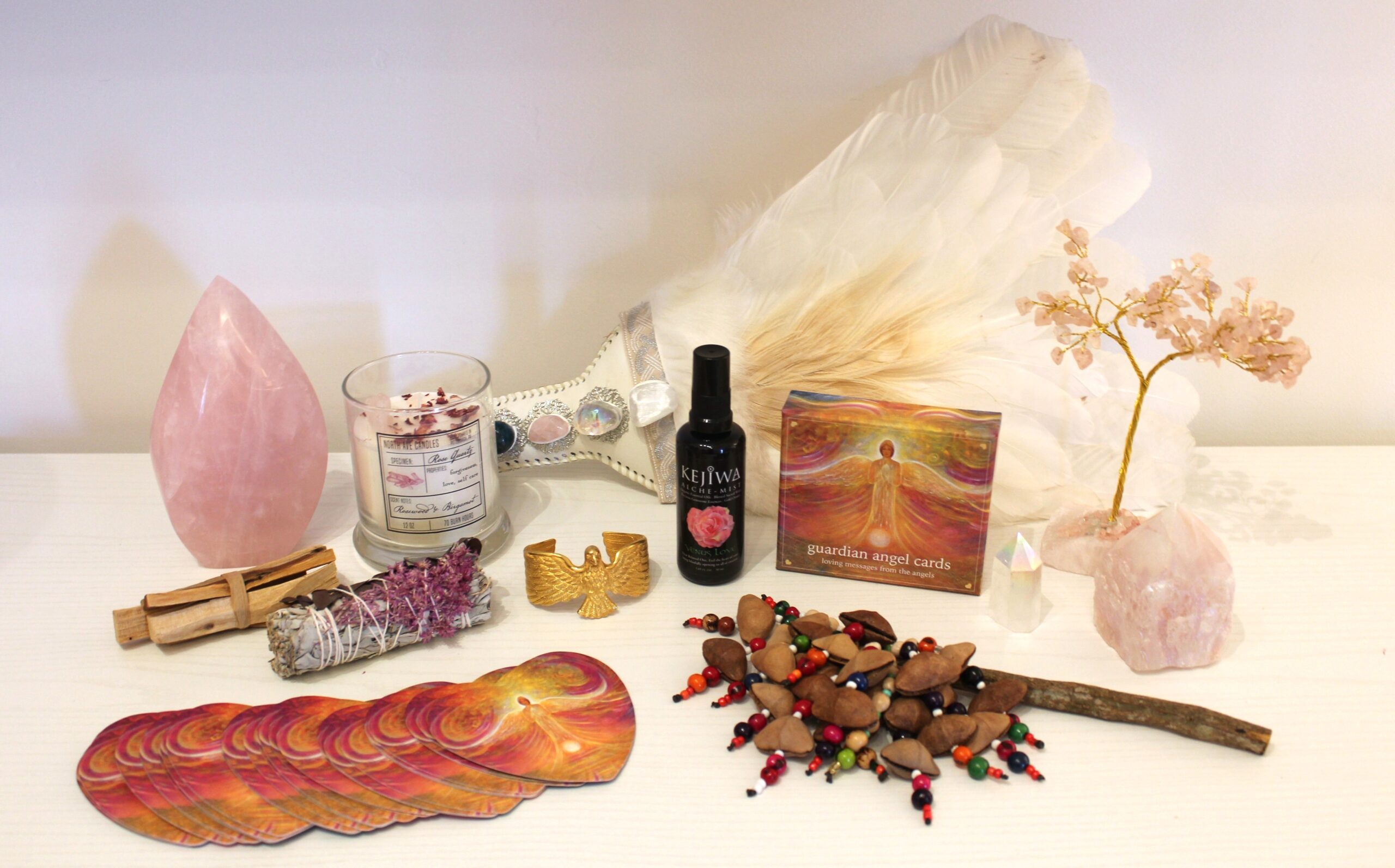 Mystical set featuring a handmade bracelet cuff with leather snake skin and crystals, mystical shaman oracle deck, medicine bag with crystal, sage wand with antlers, feathers, and crystals, plus a sage bundle with rose petals, palo santo, and celenite – perfect for Sedona healing practices.