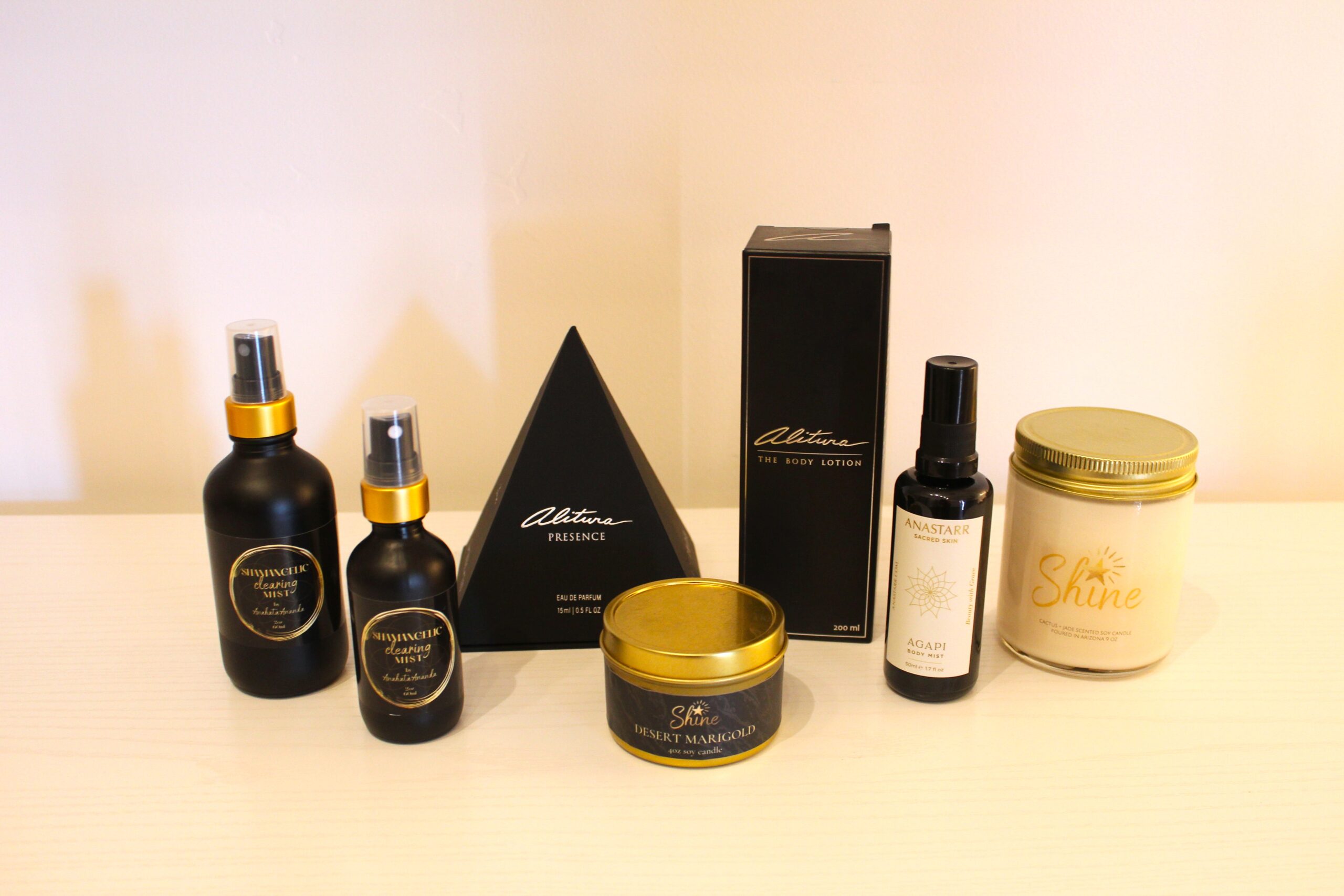 Holistic self-care essentials including bath salts, aromatic candles, refreshing sprays, and a geode crystal heart, curated for wellness at our Sedona boutique.