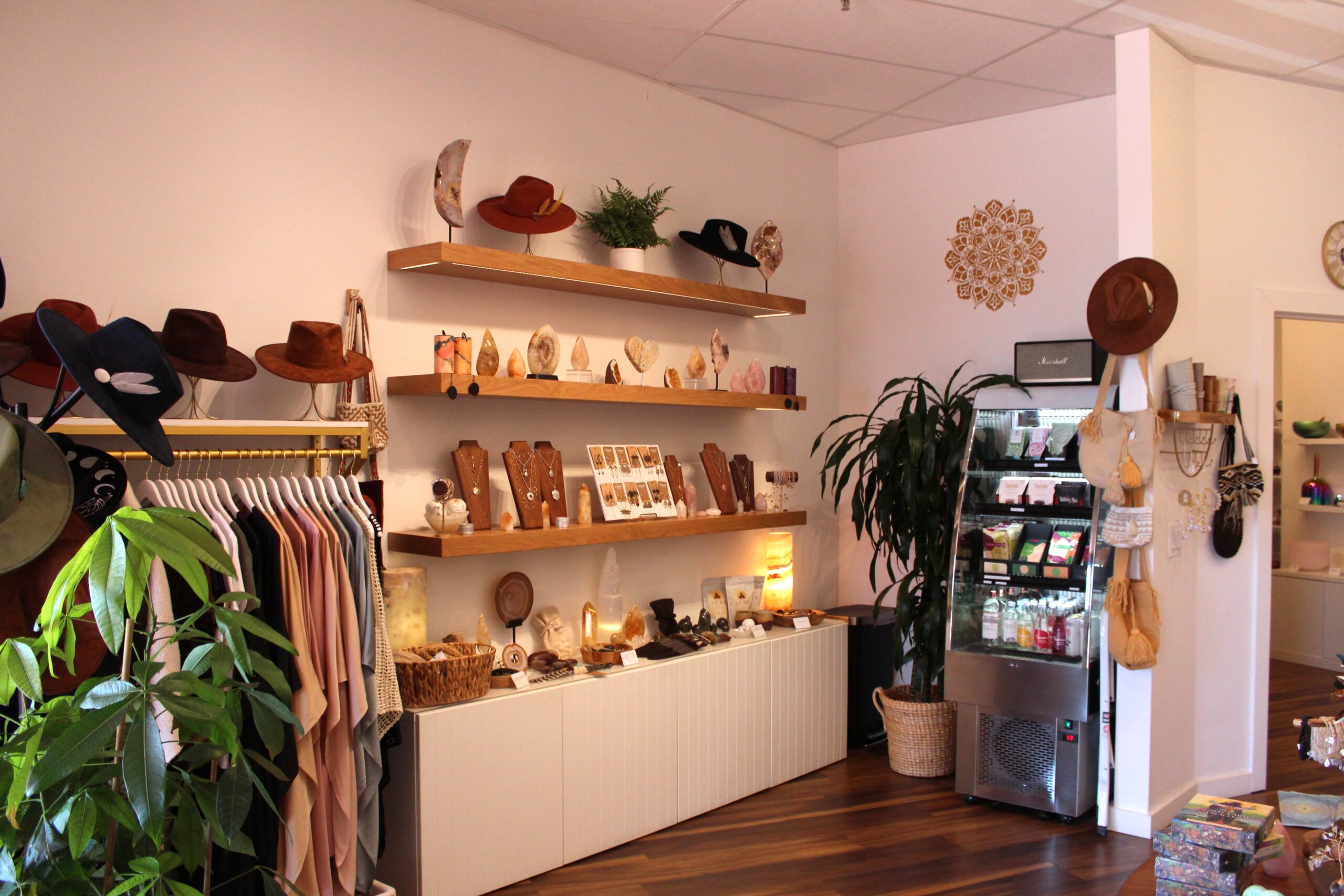 Sound healer performing with sacred instruments and altar in a high-vibe Sedona venue rental space featuring angel wings.