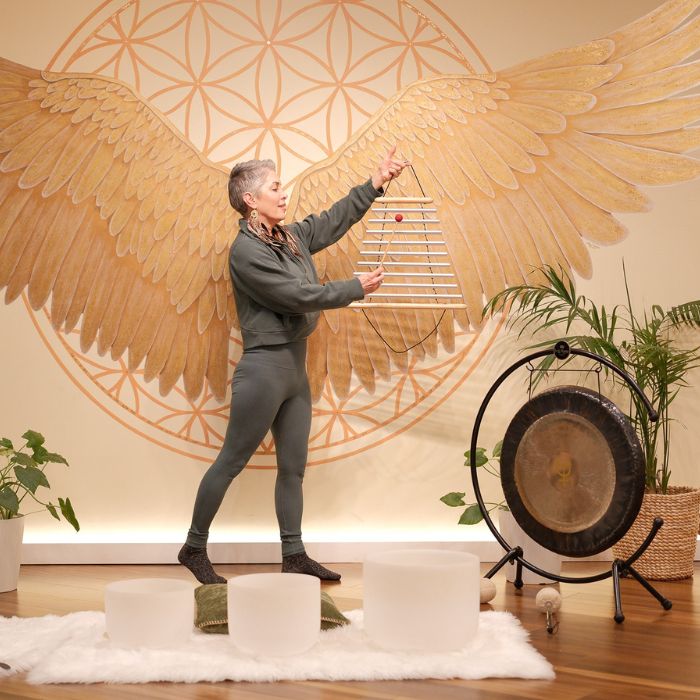 A sound healing practitioner in action, using singing bowls and vibrational therapy to create a deep healing experience during a training session in Sedona.